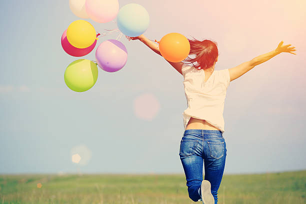 istock young asian woman  with colored balloons 532648019