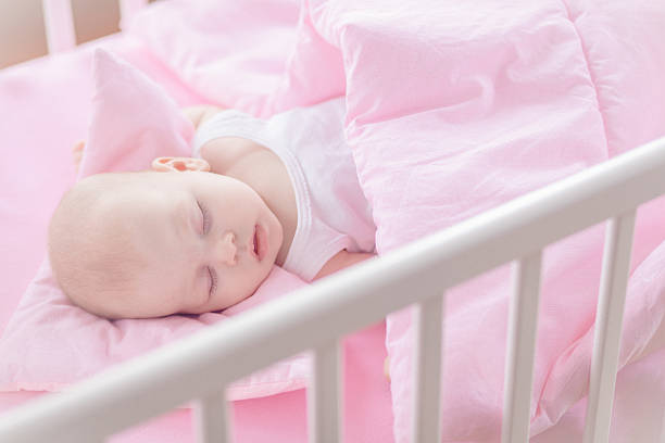 istock Cute baby girl sleeping in white crib 532663809