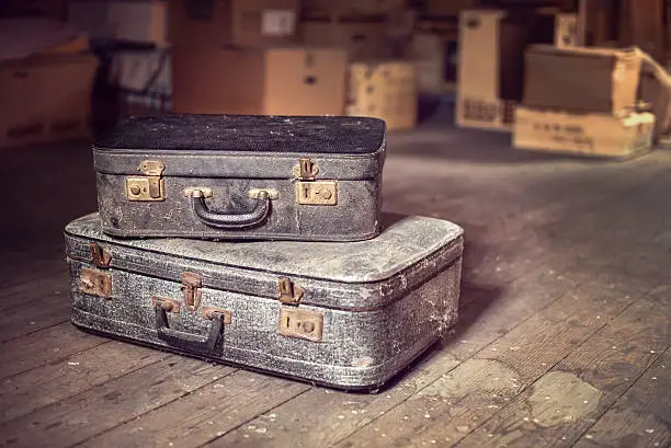 Old vintage suitcases in a dusty attic