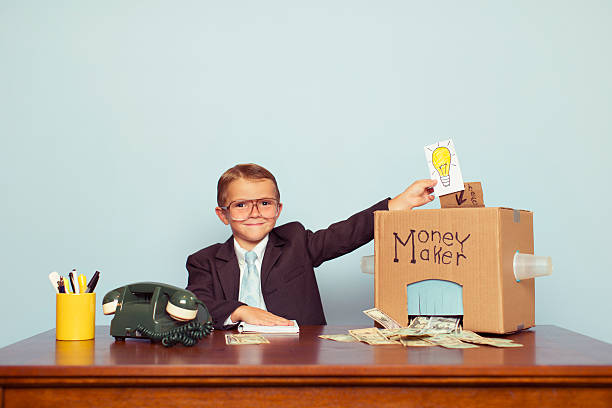 istock Business Boy Puts Ideas in Machine and Makes Money 532666073
