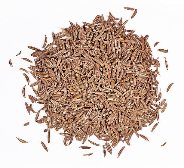 istock Heap of cumin seeds on a white 532666277