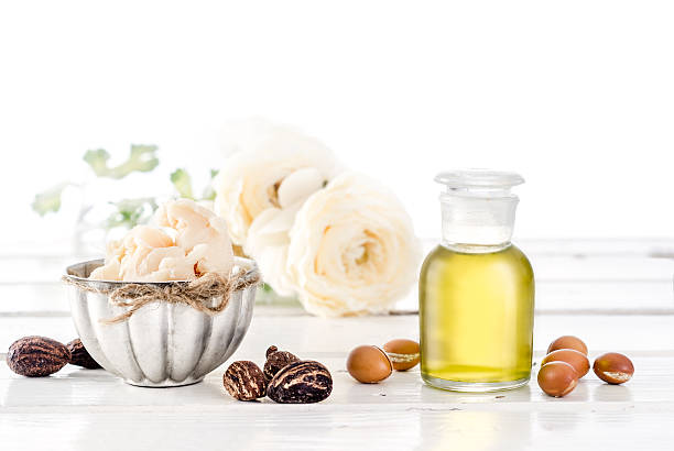 Argan oil and fruits with Shea butter and nuts stock photo