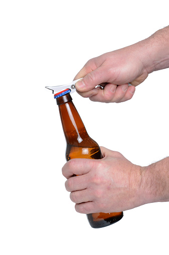 man opening bottle with opener isolated white background