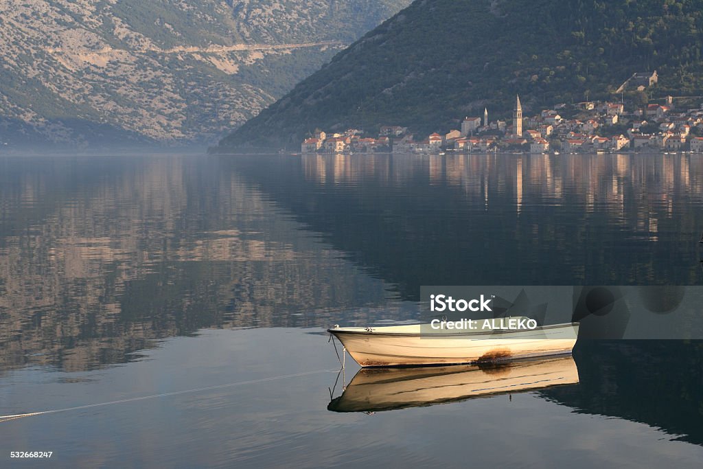 Old fishing boat in the morning mist, Bay of Kotor Old fishing boat in the early morning fog in the Bay of Kotor in Montenegro. 2015 Stock Photo