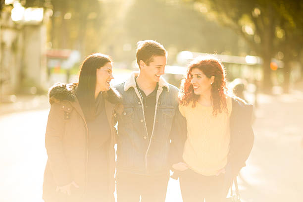 istock Three friends walk the town streets 532671451