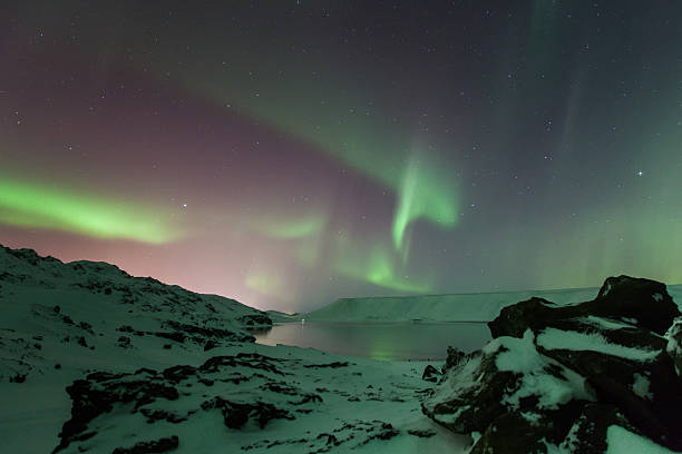 istock Aurora Borealis curls above mountains and sea. 532681043