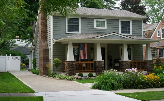 Rochester, Michigan, USA - August 16, 2014: A quaint house in a leafy neighborhood of Rochester, Michigan. Rochester is a bedroom community of Detroit, Michigan, with many residents employed by the automotive industry. It has been named one of the best places to live by Money Magazine.