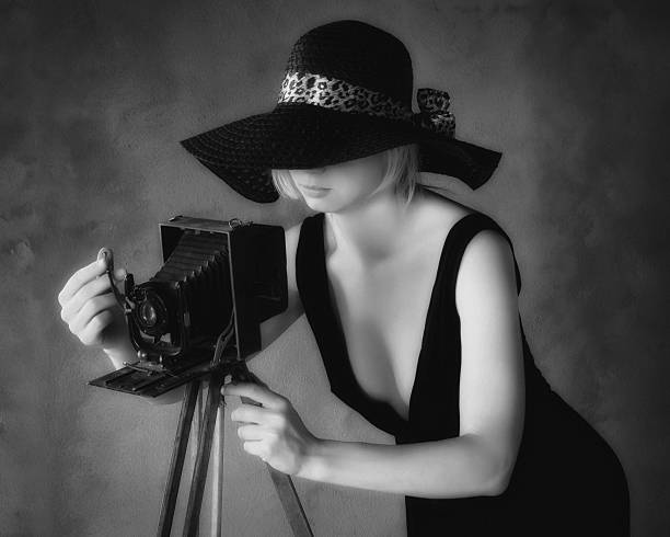 istock Girl-photographer with old camera(black and white) 532686321