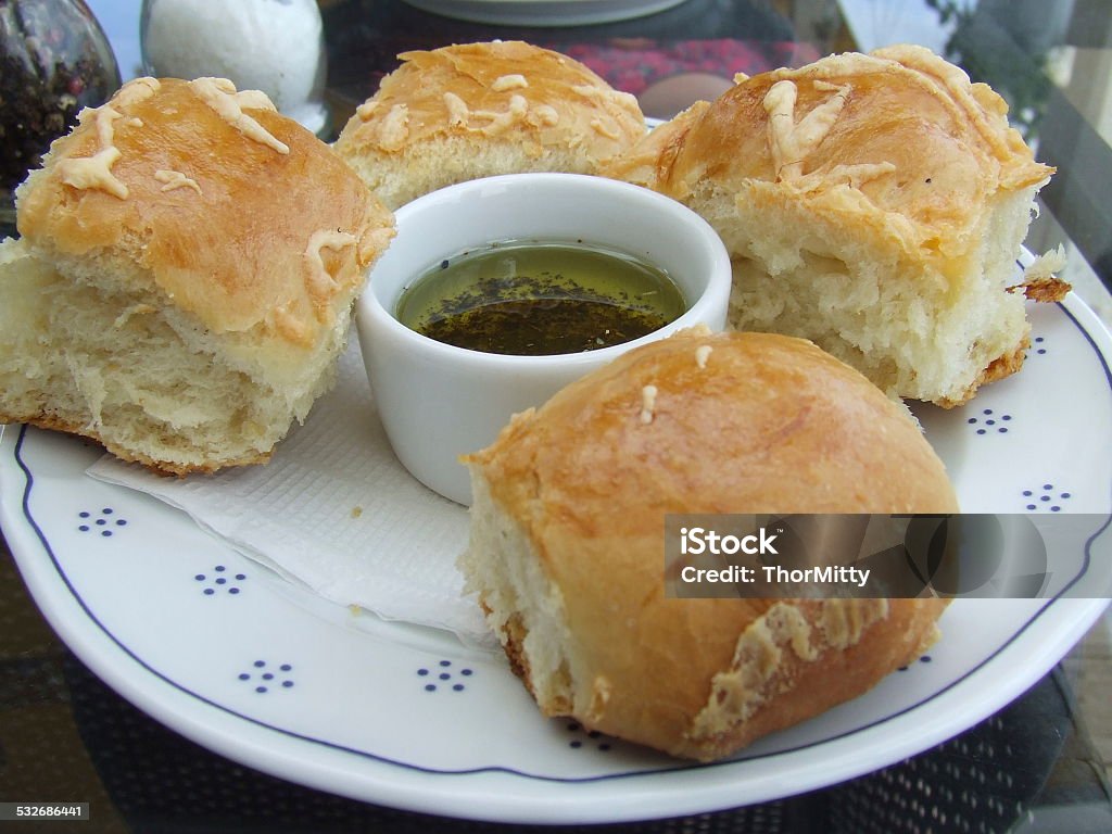 Bread Air bread rolls with garlic sauce are in the white plate on a table in a restaurant. 2015 Stock Photo