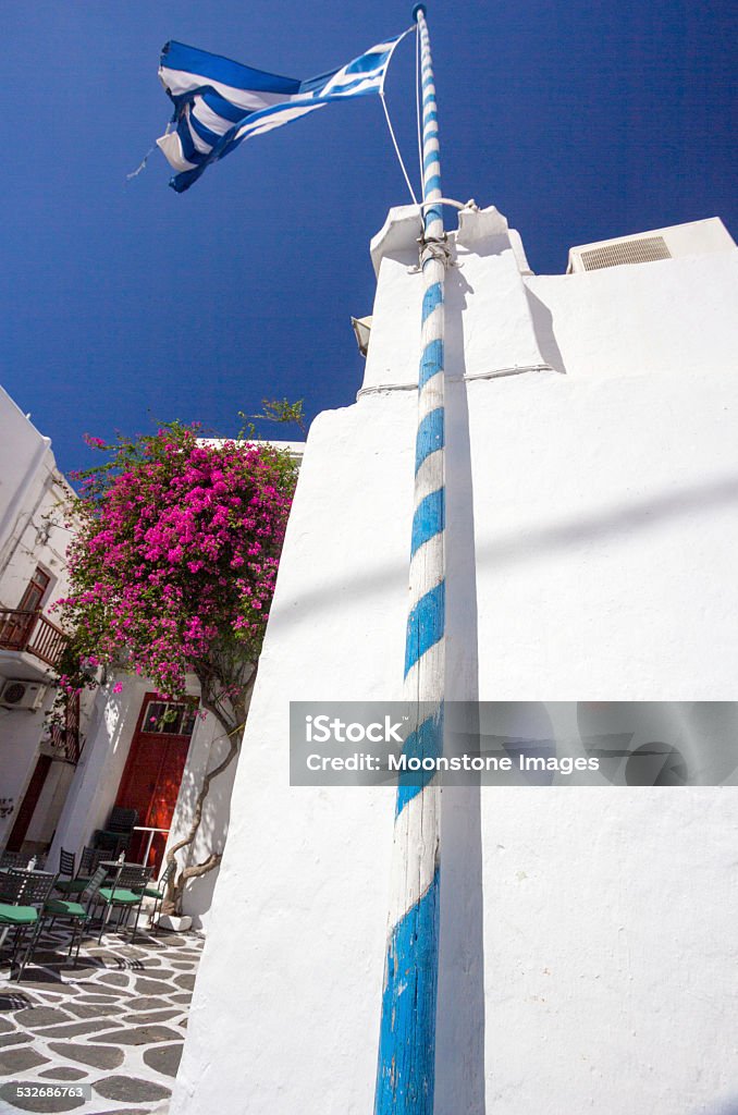 Church in Mykonos Town, Greece Traditional Greek church in Mykonos Town, with a Greek flag flying over it 2015 Stock Photo
