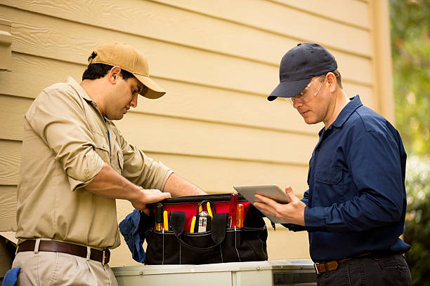 istock Air conditioner repairmen work on home unit. Blue collar workers. 532687043