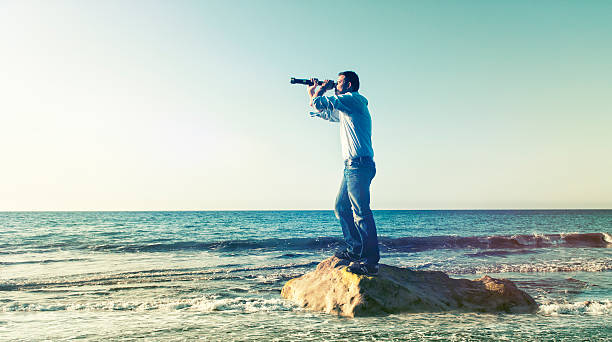 istock Explorer looking for his next discovery with a hand-held telescope 532687137
