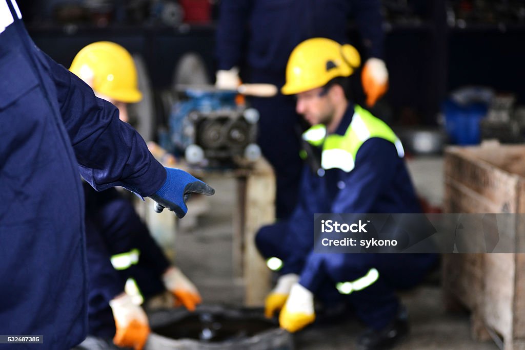 Workshop manager pointing at mechanic in 2015 Stock Photo
