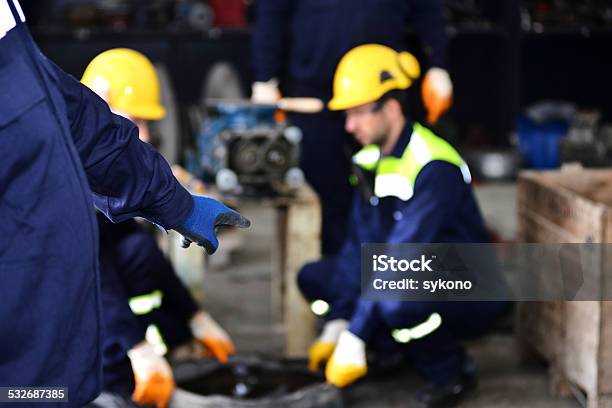 Workshop Manager Pointing At Mechanic Stock Photo - Download Image Now - 2015, Horizontal, Manager