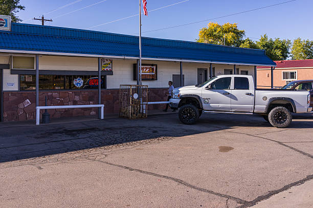 Bluff: car and woman customer in front of a store Bluff, Utah, United States - October 16, 2014: A car and a customer in front of a store in Bluff. Bluff is a small town with about 300 residents. It was founded by Mormons in 1880. Bluff. Utah. United States. mormon woman photos stock pictures, royalty-free photos & images