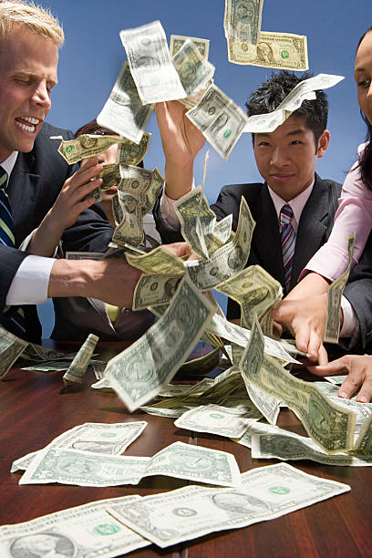 istock Businesspeople throwing money 532700413