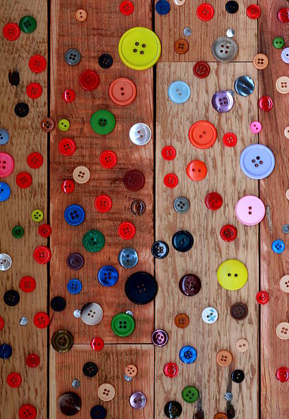 istock Scattered Buttons on Recycled Wood Background 532700683