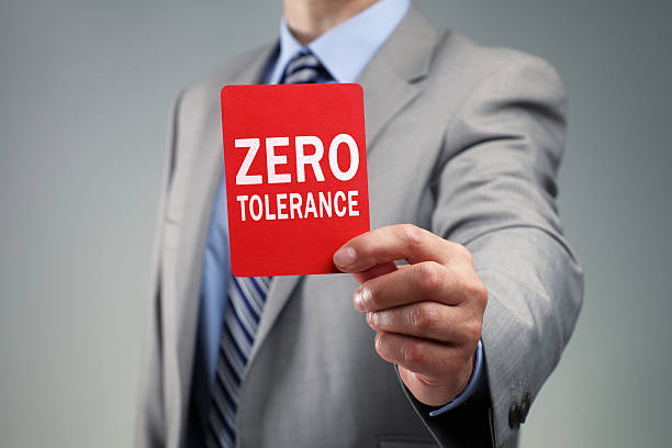 Businessman showing the zero tolerance red card Showing a zero tolerance red card concept for bad business practice, exclusion or criminal activity zero errors stock pictures, royalty-free photos & images