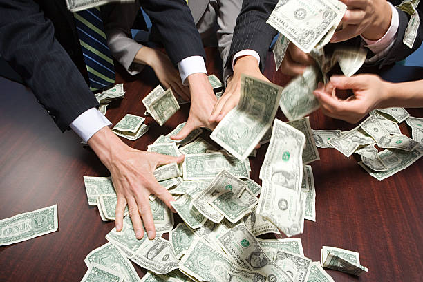 Businesspeople grabbing money