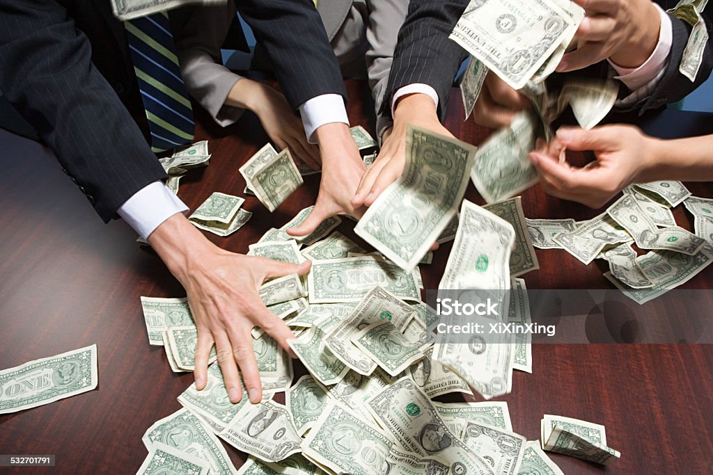 Businesspeople grabbing money Currency Stock Photo Businesspeople grabbing money Currency Stock Photo