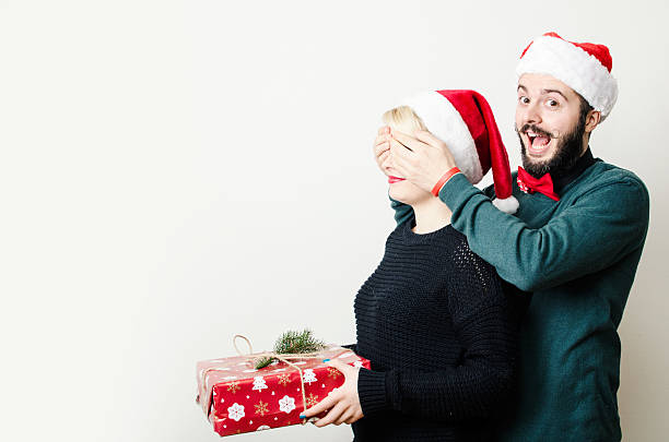 istock Festive young couple exchanging presents 532702757