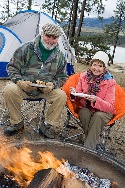 istock Senior couple eating by tent 532703233