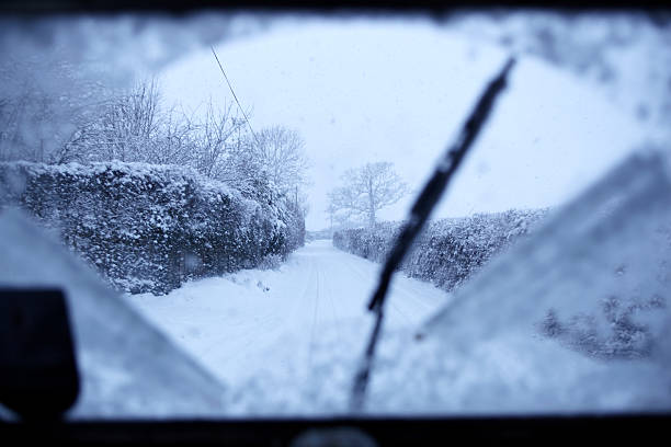 Driving Through The Snow There's nothing as relaxing as a drive in the English countryside, unless it's snowing. Then it's a whole lot more exciting. windshield wiper snow stock pictures, royalty-free photos & images
