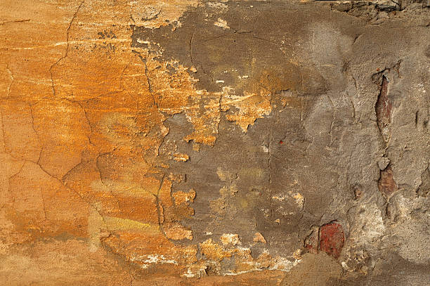 istock Texture of old wall covered with yellow stucco 532704895