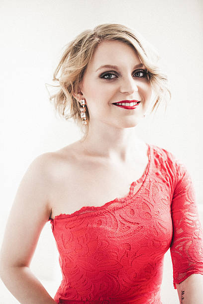 Young woman in bright light Young woman in bright light, wearing red dress. sequence dress stock pictures, royalty-free photos & images