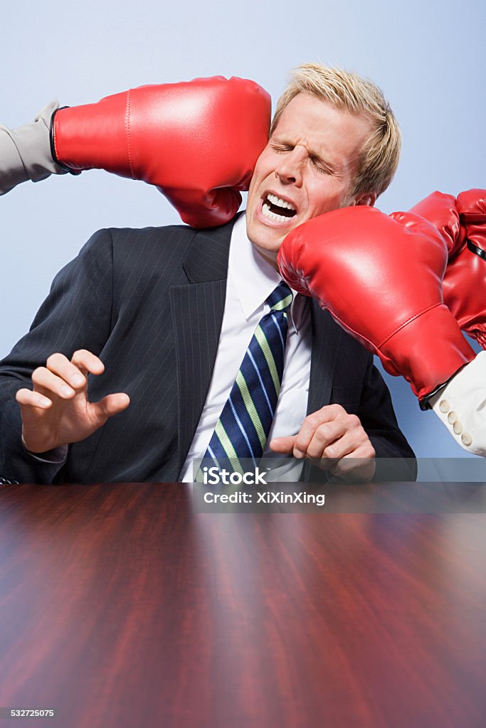 Businessman getting punched Businessman Stock Photo