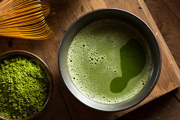 Organic Green Matcha Tea Organic Green Matcha Tea in a Bowl matcha tea photos stock pictures, royalty-free photos & images