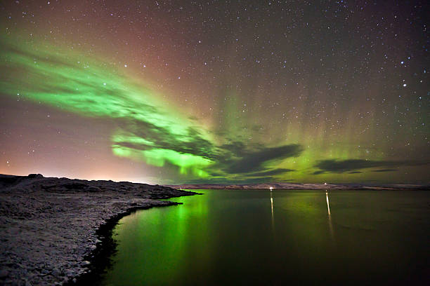 istock Aurora Borealis curls above mountains and sea. 532731025