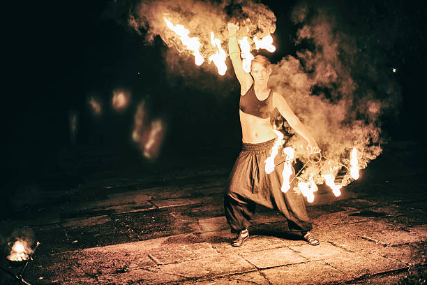 istock active girls carries out tricks for fire show at night 532731629