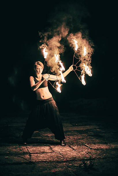istock active girls carries out tricks for fire show at night 532731631