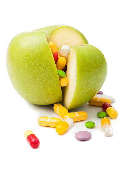 istock Green apple filled with drugs concept 532749579