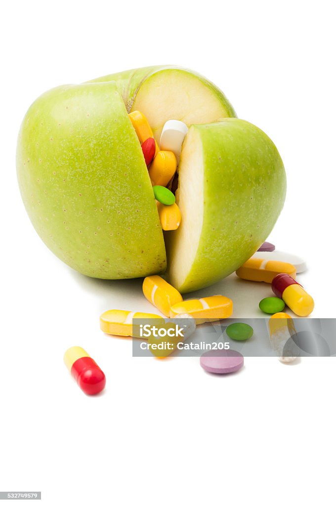 Green apple filled with drugs concept Natural green apple  filled with various colored drugs 2015 Stock Photo