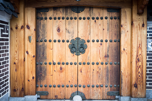 Traditional and retro Korean door with knockers and decorations.
