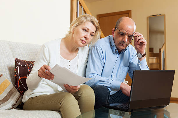istock Serious mature man and woman reading finance documents 532750271
