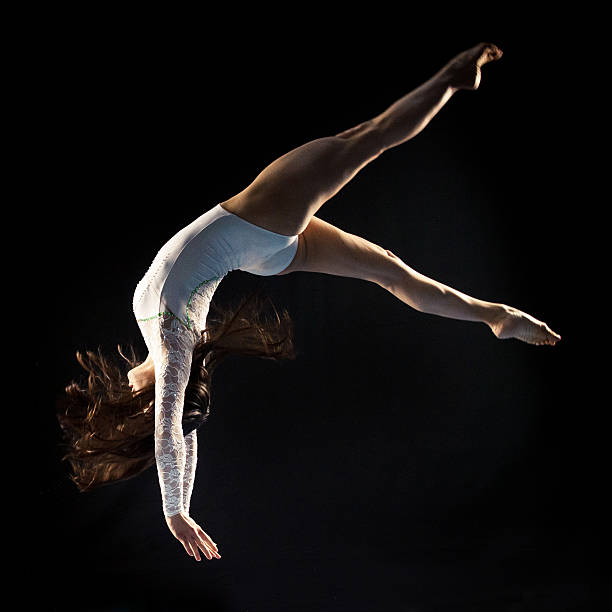 istock Young woman doing gymnastics jump 532750537