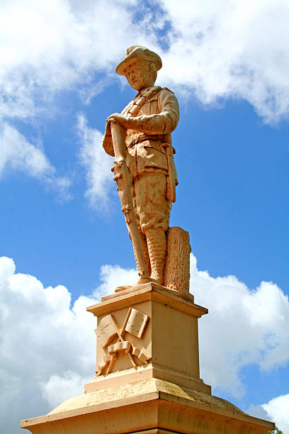 ANZAC Day World War 1 Cenotaph Statue A World War 1 Sandstone cenotaph statue stands guard over an ANZAC Day memorial service. larrikin stock pictures, royalty-free photos & images