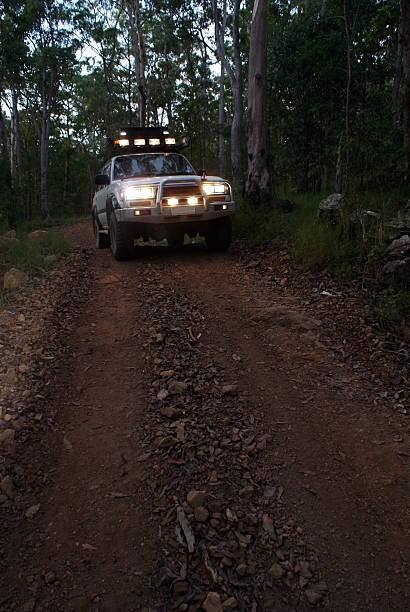 istock 4x4 with lights on at dusk 532751769
