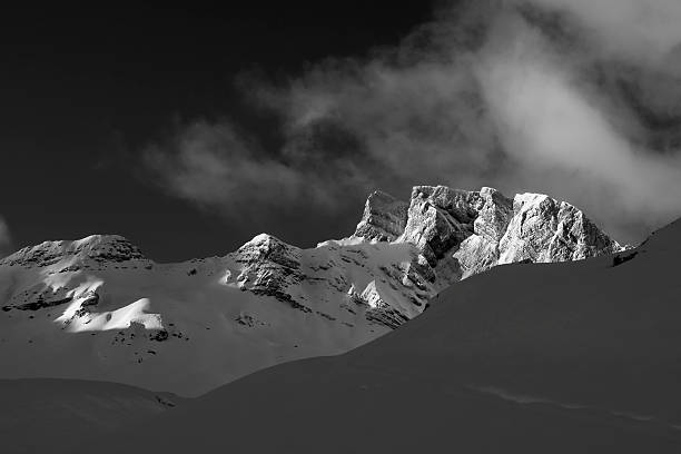 istock Snow capped mountain range illuminated from the morning sun 532770339