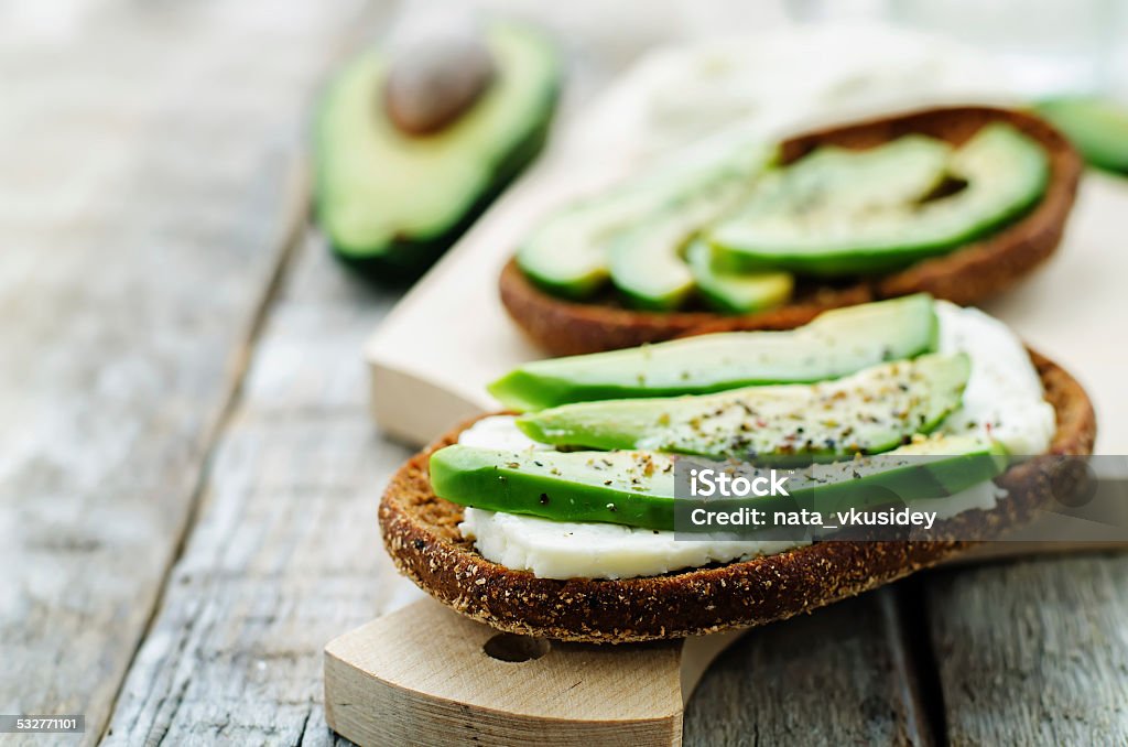 sandwich of rye bread with avocado and goat cheese sandwich of rye bread with avocado and goat cheese. tinting. selective focus 2015 Stock Photo