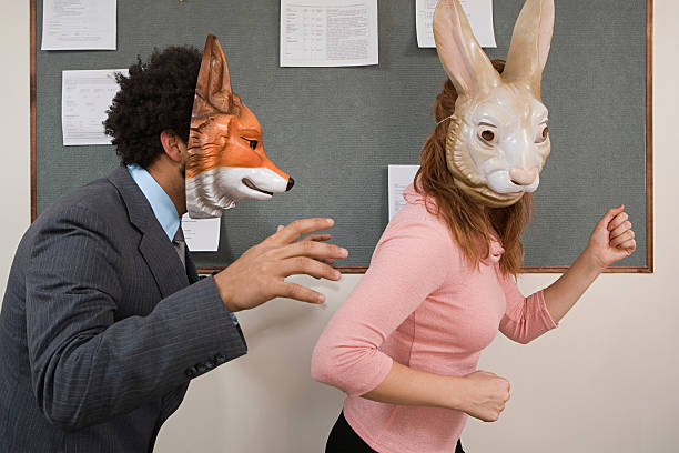istock Office workers fooling around in masks 532772535