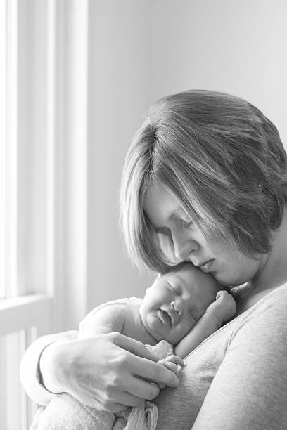 istock Mother embracing newborn baby 532772679