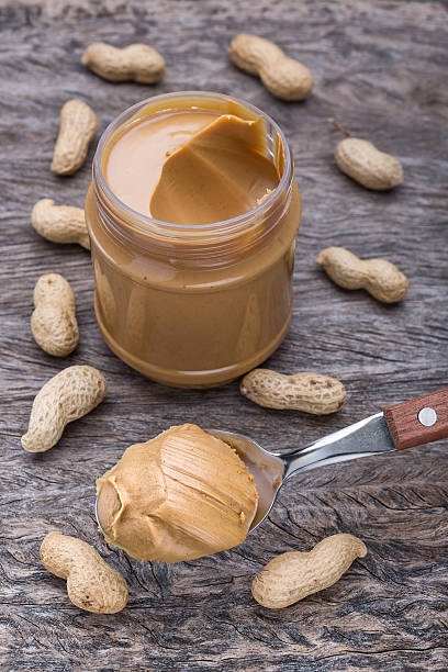 istock Peanut cream in spoon. On a background of nuts. 532774151