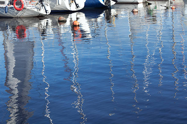 istock Reflection of masts in the blue water 532775507