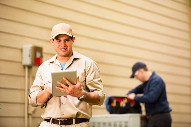istock Air conditioner repairmen work on home unit. Blue collar workers. 532786195