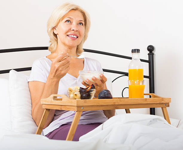 istock mature woman enjoying healthy breakfast 532786323