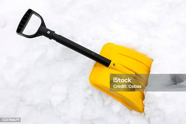 Yellow Snow Shovel On White Snow Stock Photo - Download Image Now - 2015, Chores, Cold Temperature